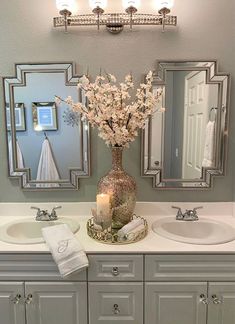 a bathroom with two sinks and mirrors on the wall