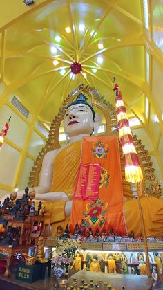 a large buddha statue sitting inside of a building