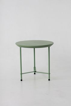 a green table with two black legs on a white background and the top half turned upside down