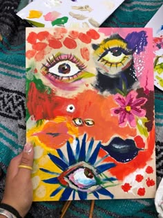 someone is painting an art project with flowers and eyeballs