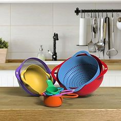 colorful pots and pans sit on a kitchen counter