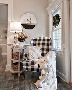 a living room filled with furniture and a large clock on the wall above it's windows