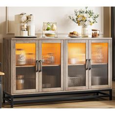 a sideboard with glass doors in a living room