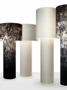 four lamps with different shades of black, white and grey on the same lamp shade