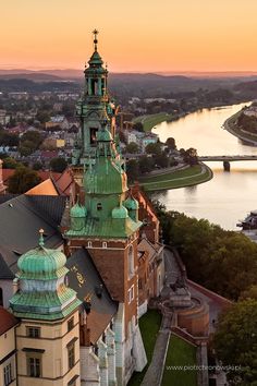 an aerial view of a building with a river in the background