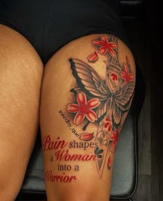 a woman's thigh with tattoos and words written on it, sitting in a suitcase