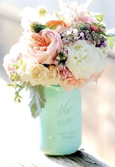 a vase filled with flowers sitting on top of a wooden table