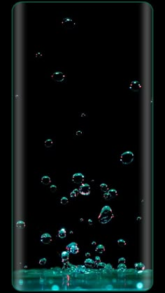 soap bubbles floating in the water on a black background