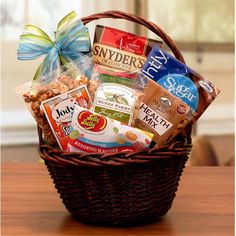 a basket filled with snacks sitting on top of a wooden table