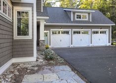 a large house with two garages in the front and one on the other side