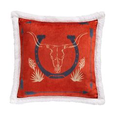 a red pillow with a longhorn skull on it's side and white fur trim around the edges