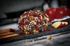 an apple and cheese ball with crackers next to it