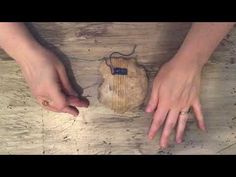 two hands reaching for an object on a wooden table