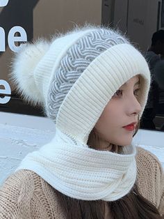 a woman wearing a white hat and scarf