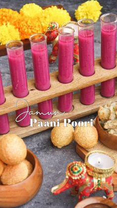 there are many candles and bowls with food on the table in front of each other