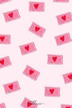 pink envelopes with hearts on them and the word love is in the air above them