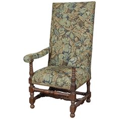 an upholstered arm chair with floral fabric