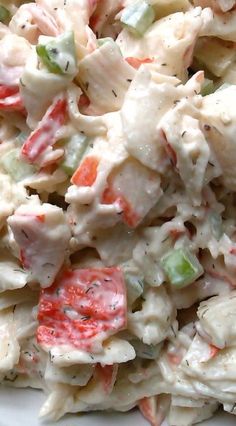 a white plate topped with a salad covered in dressing