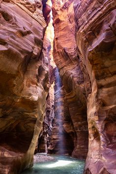 a narrow canyon with water running through it