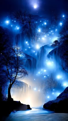 a waterfall with lights in the water and trees on both sides, surrounded by fog