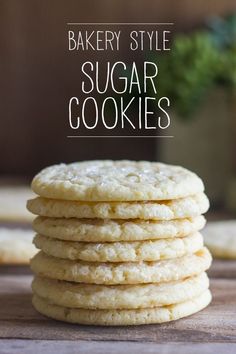 a stack of sugar cookies sitting on top of a wooden table