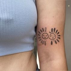 two people with sun and moon tattoos on their arms