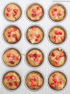 some cupcakes with strawberries in them are ready to be baked into muffin tins