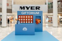 the interior of a shopping mall with an advertisement for myer's giftorium