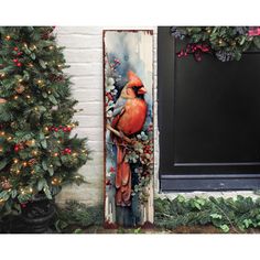 a painting of a cardinal perched on a branch in front of a door with christmas decorations