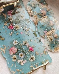 a blue tray with flowers on it sitting on top of a white cloth covered table