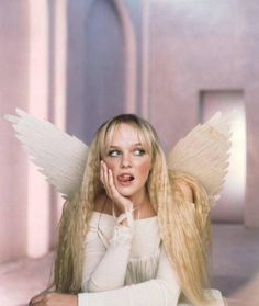 a woman with long blonde hair and angel wings