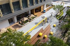 an aerial view of the outside of a building with benches and trees in front of it