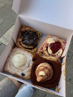 a box filled with different types of pastries