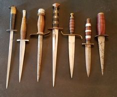 five different types of knives lined up in a row next to each other on a table