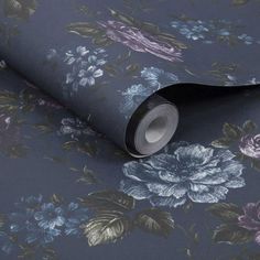 a blue floral wallpaper with purple and pink flowers on the bottom half of it