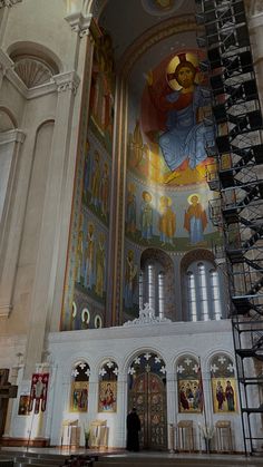 the interior of a church with many paintings on the walls