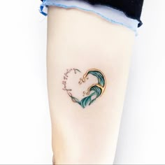 a woman's leg with a heart shaped wave tattoo on it