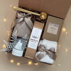 a christmas gift box with candles, socks and other items