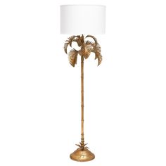 a gold palm tree lamp with a white shade