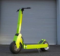 a lime green scooter is parked in front of a garage with roller doors