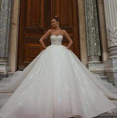 a woman standing in front of a door wearing a wedding dress with sequins