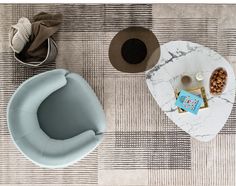 two chairs and a coffee table on a carpeted floor, one with a bowl of nuts next to it