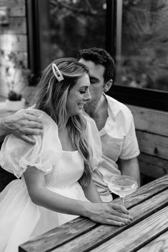 a man and woman sitting next to each other on a bench