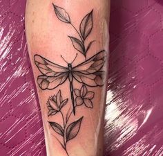 a black and white photo of a dragonfly on the leg