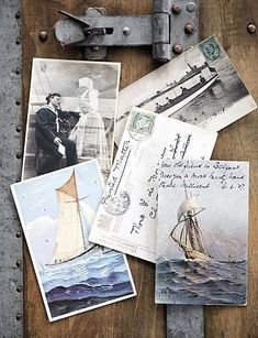 several old postcards are laying on top of a piece of wood with an antique lock