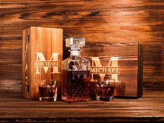 two bottles of whiskey sitting on top of a wooden box