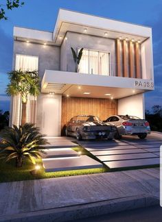 two cars parked in front of a modern house