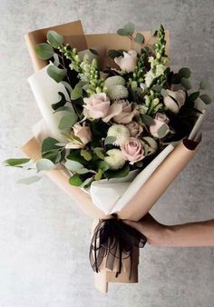 a person holding a bouquet of flowers in their hand