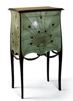 a green cabinet with an intricate design on it