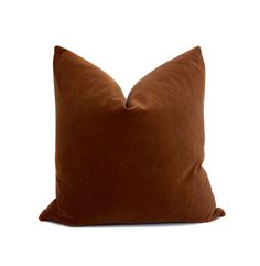 a brown pillow on a white background